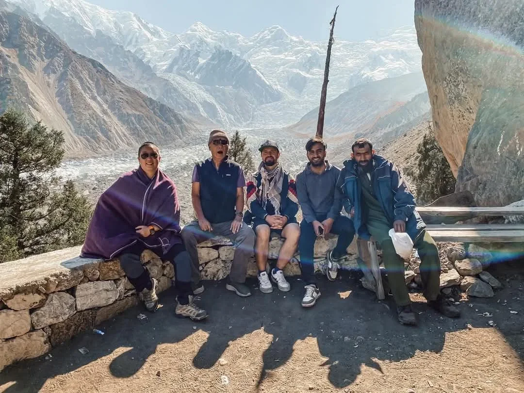 Pakistan tour operator The Golden Adventure team with travellers above a glacier valley in Gilgit-Baltistan