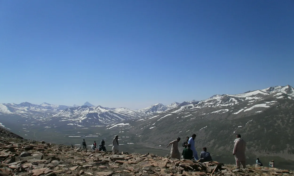 Riders resting at the top of the Babusar Pass above the Kaghan Valley, Pakistan