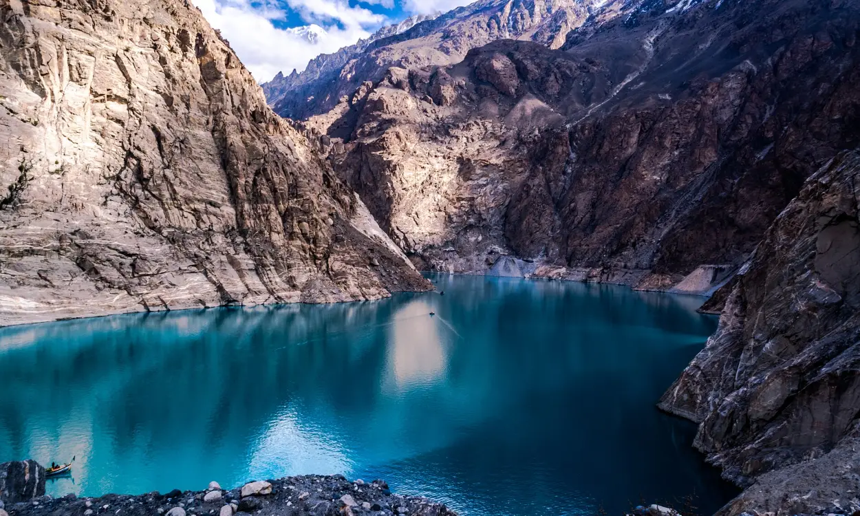 The turquoise Attabad Lake between rocky cliffs in Gojal, Upper Hunza, Pakistan