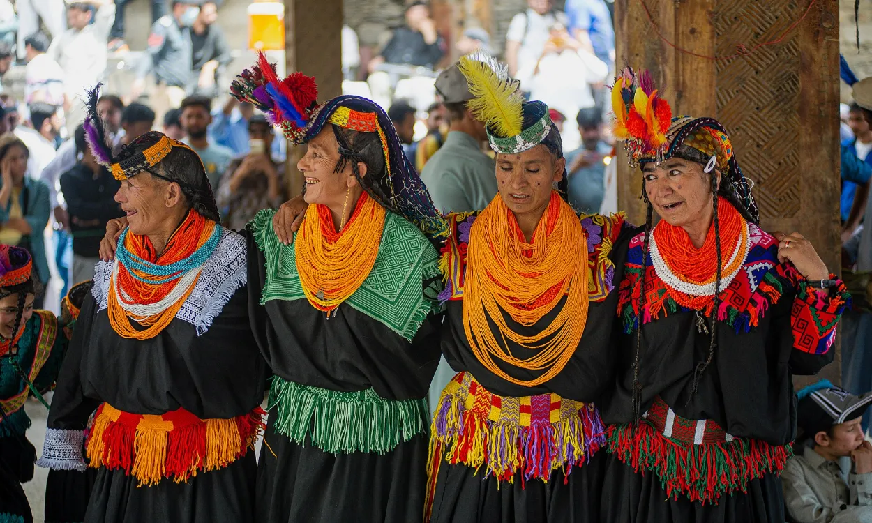 Kalash women in traditional dress dancing at the Chilam Joshi spring festival, Kalash Valley, Pakistan