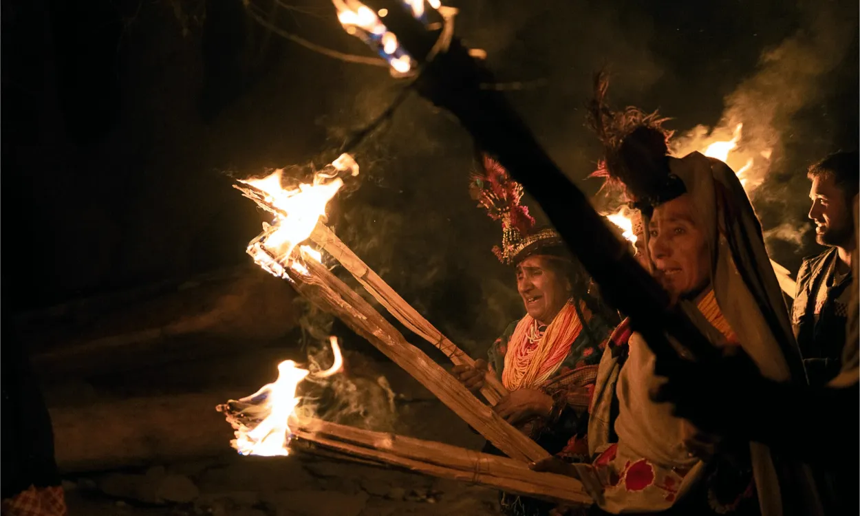 Kalash people carrying burning torches during the Chaumos winter festival in Bumburet, Pakistan