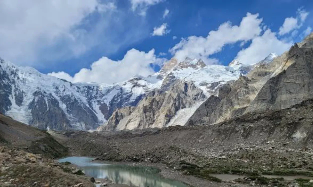 Masherbrum peaks above a glacial pool on the Masherbrum Base Camp Trek