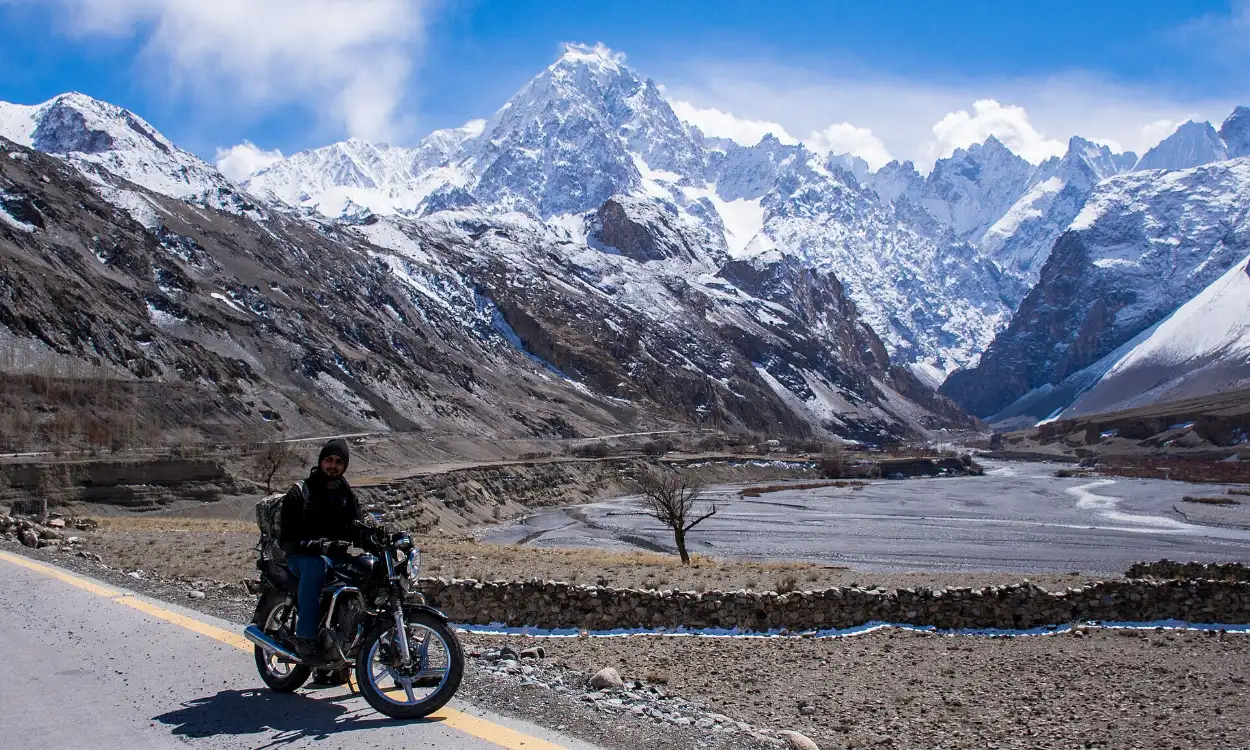 Motorcyclist riding the Karakoram Highway in Upper Hunza, Pakistan
