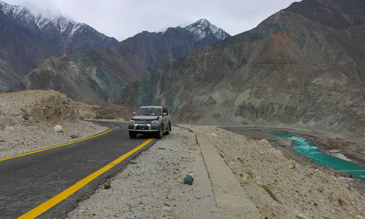 4x4 vehicle on the Karakoram Highway beside the Hunza River, Pakistan