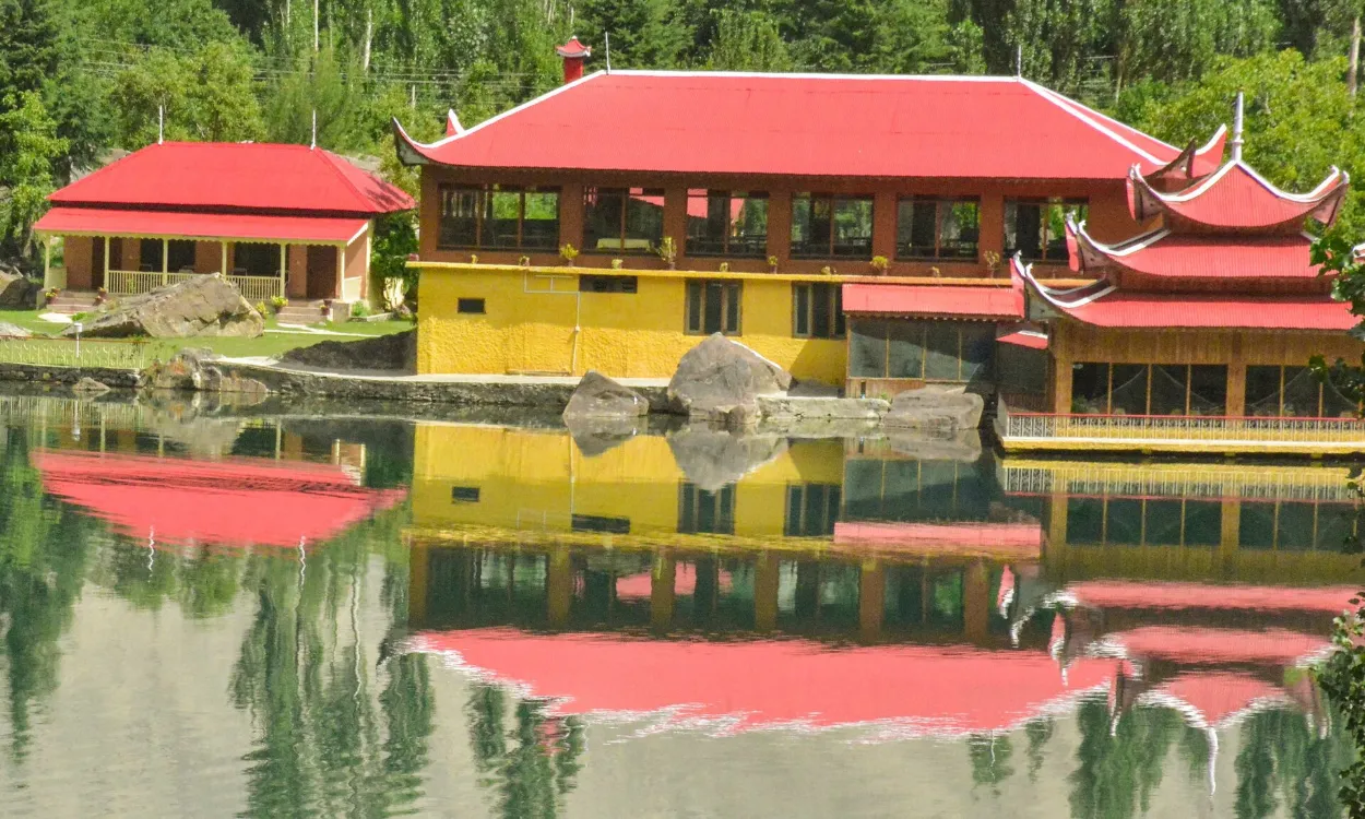 The red-roofed Shangrila Resort reflected in Lower Kachura Lake, Skardu, Pakistan