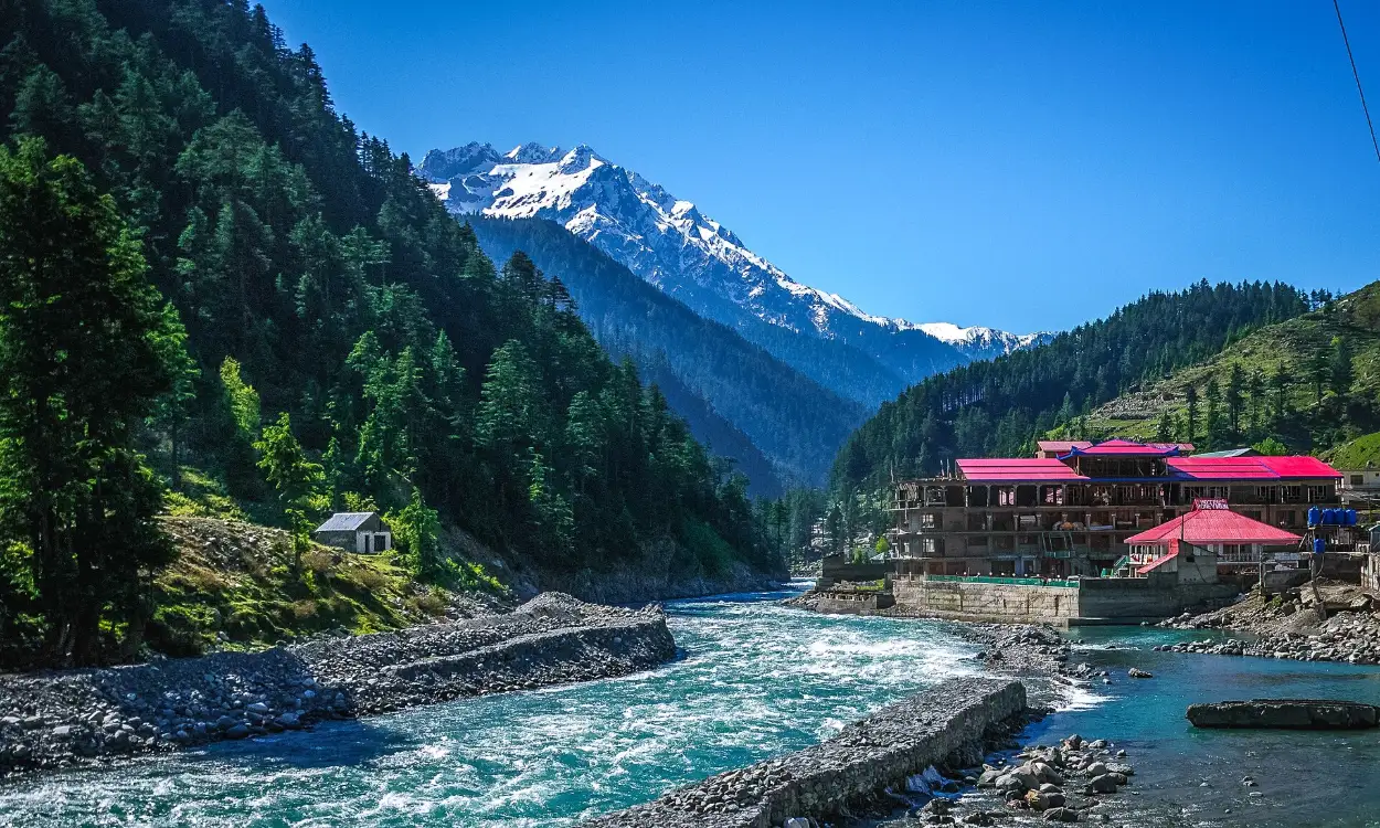 The Swat River flowing past a riverside hotel in Kalam, Swat Valley, Pakistan