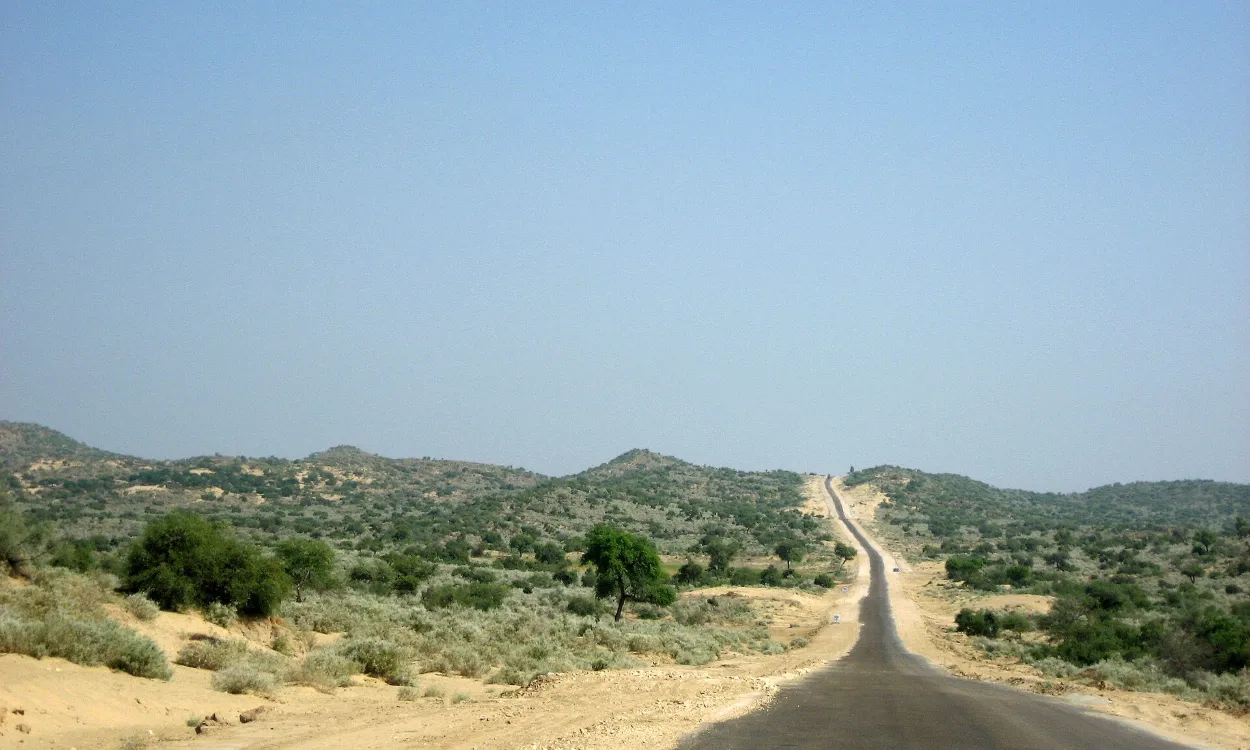 A desert road through the scrubland of Tharparkar in the Thar Desert, Sindh, Pakistan